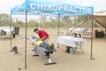 Chiropractor assisting cyclist at finish line at the Mathaithai